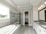 Master Bathroom with Oversize Frameless Glass Shower and Designer Tile at Provence by Waterford Homes at Regency Point